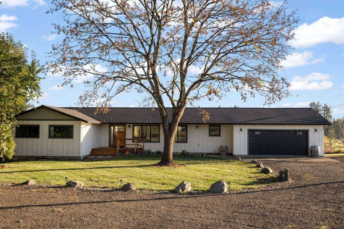 A welcoming view of the home's exterior, with a large tree in front, manicured lawn, and entryway. The inviting scene suggests a safe and peaceful environment for families, with space for children to play and families to gather outdoors.